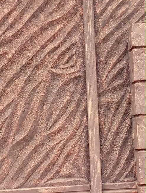 Textured wall panel framed with wood-effect moulding