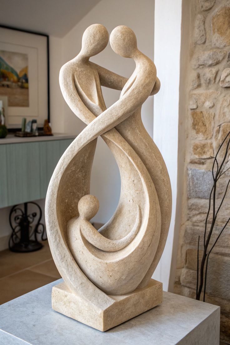 Stone sculpture of two parents embracing a child